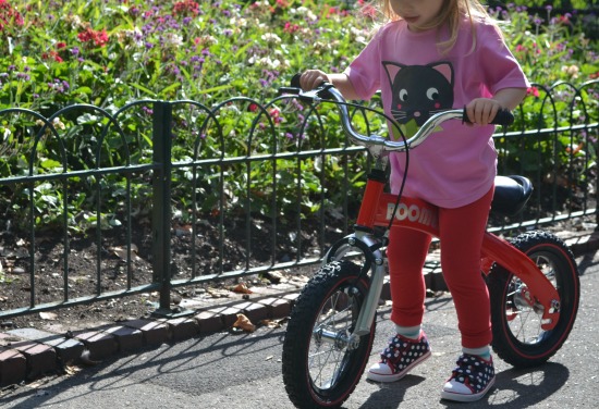 Toddler girl on balance bike in the park
